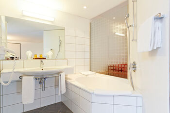 bathroom, classic hotel room at Hotel Hirschen Wildhaus
